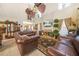 Elegant living room featuring high ceilings, a fireplace, and classic leather furniture at 165 Babbling Brook, Mcdonough, GA 30252