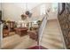 Elegant living room with high ceilings, a staircase, and classic leather furniture at 165 Babbling Brook, Mcdonough, GA 30252
