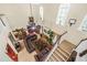 Spacious living room featuring a leather sofa, fireplace, and open staircase at 165 Babbling Brook, Mcdonough, GA 30252