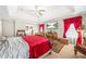 Main bedroom with tray ceilings, red drapery, and decorative furniture at 165 Babbling Brook, Mcdonough, GA 30252