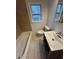 Bathroom featuring a tub with a shower and a vanity at 211 Wellington Sw St, Atlanta, GA 30314