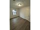 Bedroom featuring wood-look floors and a white door and trim at 211 Wellington Sw St, Atlanta, GA 30314