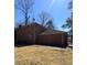 Spacious brick home featuring a two-car garage and large backyard with mature trees at 4625 Orkney Sw Ln, Atlanta, GA 30331