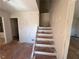 Staircase needing renovation, providing access to the home's upper level at 4625 Orkney Sw Ln, Atlanta, GA 30331