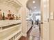 Walk-through butler's pantry featuring white shelving and storage, adjacent to the kitchen and dining area at 2461 Melton Common Dr, Dacula, GA 30019