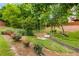Picturesque backyard featuring well-maintained lawn, colorful flowerbeds, and a small bridge at 2474 Whiteoak Se Run # 18, Smyrna, GA 30080