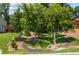 Well-manicured backyard with mature trees, grassy areas, and walking path with bridge at 2474 Whiteoak Se Run # 18, Smyrna, GA 30080