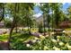 Serene backyard with lush greenery, trees, a small bridge, and landscaped garden at 2474 Whiteoak Se Run # 18, Smyrna, GA 30080