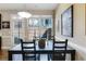 Dining area with a dark wood table, chairs, and a window looking out to the backyard at 2474 Whiteoak Se Run # 18, Smyrna, GA 30080