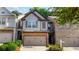 Charming townhome features a brick facade, two-car garage, and well-maintained landscaping at 2474 Whiteoak Se Run # 18, Smyrna, GA 30080