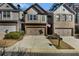 Charming townhome showcasing a stone and siding facade, two-car garage, and well-kept landscaping at 2474 Whiteoak Se Run # 18, Smyrna, GA 30080
