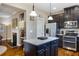 Open kitchen features granite counters, stainless appliances, island, and dark wood cabinets at 2474 Whiteoak Se Run # 18, Smyrna, GA 30080