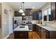 Modern kitchen features dark cabinets, stainless steel appliances, and granite countertops at 2474 Whiteoak Se Run # 18, Smyrna, GA 30080