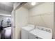 Bright laundry area with shelving, a washer, and a dryer ready for convenient chores at 2474 Whiteoak Se Run # 18, Smyrna, GA 30080