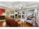 Bright living room featuring hardwood floors, coffered ceilings, fireplace, and open layout to the kitchen and dining area at 2474 Whiteoak Se Run # 18, Smyrna, GA 30080