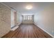 The finished basement features wood-look floors, white brick accent wall, and natural light at 3680 Brookcrest Cir, Decatur, GA 30032
