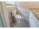 Cozy bathroom features gray tile floors, granite vanity, and modern toilet at 3680 Brookcrest Cir, Decatur, GA 30032