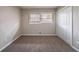 This bedroom features neutral paint, carpeted floors, and a window for natural light at 3680 Brookcrest Cir, Decatur, GA 30032