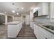 Bright kitchen features an island, granite countertops, stainless steel microwave, and updated backsplash at 3680 Brookcrest Cir, Decatur, GA 30032