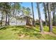 Back of property featuring a lawn, mature trees, and a side-entry garage at 3973 Elmscourt Dr, Stone Mountain, GA 30083