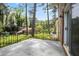 View from the backyard featuring a deck with an iron railing and the lawn with mature trees in the background at 3973 Elmscourt Dr, Stone Mountain, GA 30083
