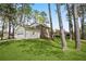 Back of property featuring a lawn, mature trees, and a side-entry garage at 3973 Elmscourt Dr, Stone Mountain, GA 30083