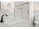 Bathroom with a marble wall, bathtub, and vanity sink at 3973 Elmscourt Dr, Stone Mountain, GA 30083