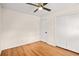 Neutral bedroom with hardwood floors, white walls, ceiling fan, and closet with sliding doors at 3973 Elmscourt Dr, Stone Mountain, GA 30083