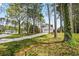 A single-Gathering house with a two-car garage and long drive is surrounded by lush, green trees at 3973 Elmscourt Dr, Stone Mountain, GA 30083