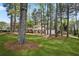 Traditional two-story home with a manicured lawn, mature trees, and charming curb appeal at 3973 Elmscourt Dr, Stone Mountain, GA 30083