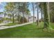 A single-Gathering house with a two-car garage and long drive is surrounded by lush, green trees at 3973 Elmscourt Dr, Stone Mountain, GA 30083