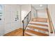 Bright foyer with hardwood floors, staircase with black iron railing, and a white front door at 3973 Elmscourt Dr, Stone Mountain, GA 30083