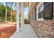 Charming brick home features a covered front porch with white columns and black shutters at 3973 Elmscourt Dr, Stone Mountain, GA 30083