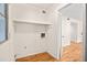 Laundry room featuring a white wall, a shelf, and light wood floors at 3973 Elmscourt Dr, Stone Mountain, GA 30083