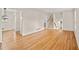 Inviting living room featuring hardwood floors, white walls, and easy access to adjoining rooms at 3973 Elmscourt Dr, Stone Mountain, GA 30083