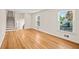 Spacious living room with hardwood floors, staircase to the second floor, and windows with natural light at 3973 Elmscourt Dr, Stone Mountain, GA 30083