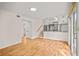 Bright living room with hardwood floors and white walls, leading into the kitchen and towards the sliding glass door at 3973 Elmscourt Dr, Stone Mountain, GA 30083