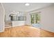 Sunlit living room with hardwood flooring and a sliding glass door overlooking the backyard at 3973 Elmscourt Dr, Stone Mountain, GA 30083