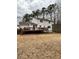 A large wooden deck on the back of a white house overlooking a large backyard at 4424 Lower Fayetteville Rd, Sharpsburg, GA 30277