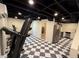 Finished basement with kitchenette, gym equipment, and stylish black and white checkered flooring at 4424 Lower Fayetteville Rd, Sharpsburg, GA 30277