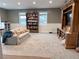Finished basement area featuring a bookshelf, television, and comfortable seating at 4424 Lower Fayetteville Rd, Sharpsburg, GA 30277