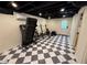 Finished basement space with checkerboard flooring and exercise equipment, offering versatility at 4424 Lower Fayetteville Rd, Sharpsburg, GA 30277