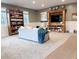 Finished basement area with a large bookcase and comfortable seating at 4424 Lower Fayetteville Rd, Sharpsburg, GA 30277