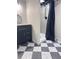 Modern bathroom with black vanity and tiled shower with black and white checkered floors at 4424 Lower Fayetteville Rd, Sharpsburg, GA 30277