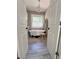 Charming bathroom with a clawfoot tub, wood-look tile, and a chandelier at 4424 Lower Fayetteville Rd, Sharpsburg, GA 30277