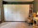 Spacious bedroom features a wall of built-in cabinets and a comfortable chair at 4424 Lower Fayetteville Rd, Sharpsburg, GA 30277