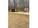 Carport and shed with a car parked underneath located behind the house with trees in the background at 4424 Lower Fayetteville Rd, Sharpsburg, GA 30277