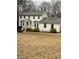 Well-maintained two-story home featuring a welcoming front porch and complemented by lush greenery at 4424 Lower Fayetteville Rd, Sharpsburg, GA 30277