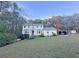 Traditional two-story home featuring a manicured lawn and mature trees at 4424 Lower Fayetteville Rd, Sharpsburg, GA 30277