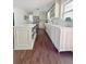 Spacious kitchen with a center island, white cabinetry, and wood flooring at 4424 Lower Fayetteville Rd, Sharpsburg, GA 30277